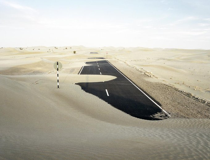 An air strip being covered by the desert